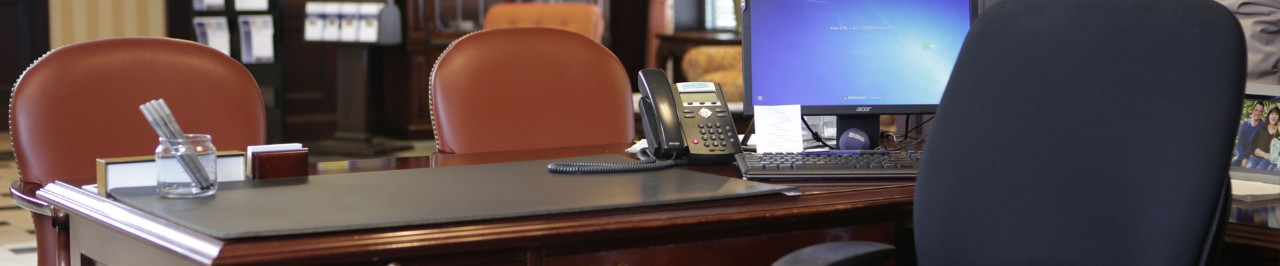 Office desk with laptop and phone